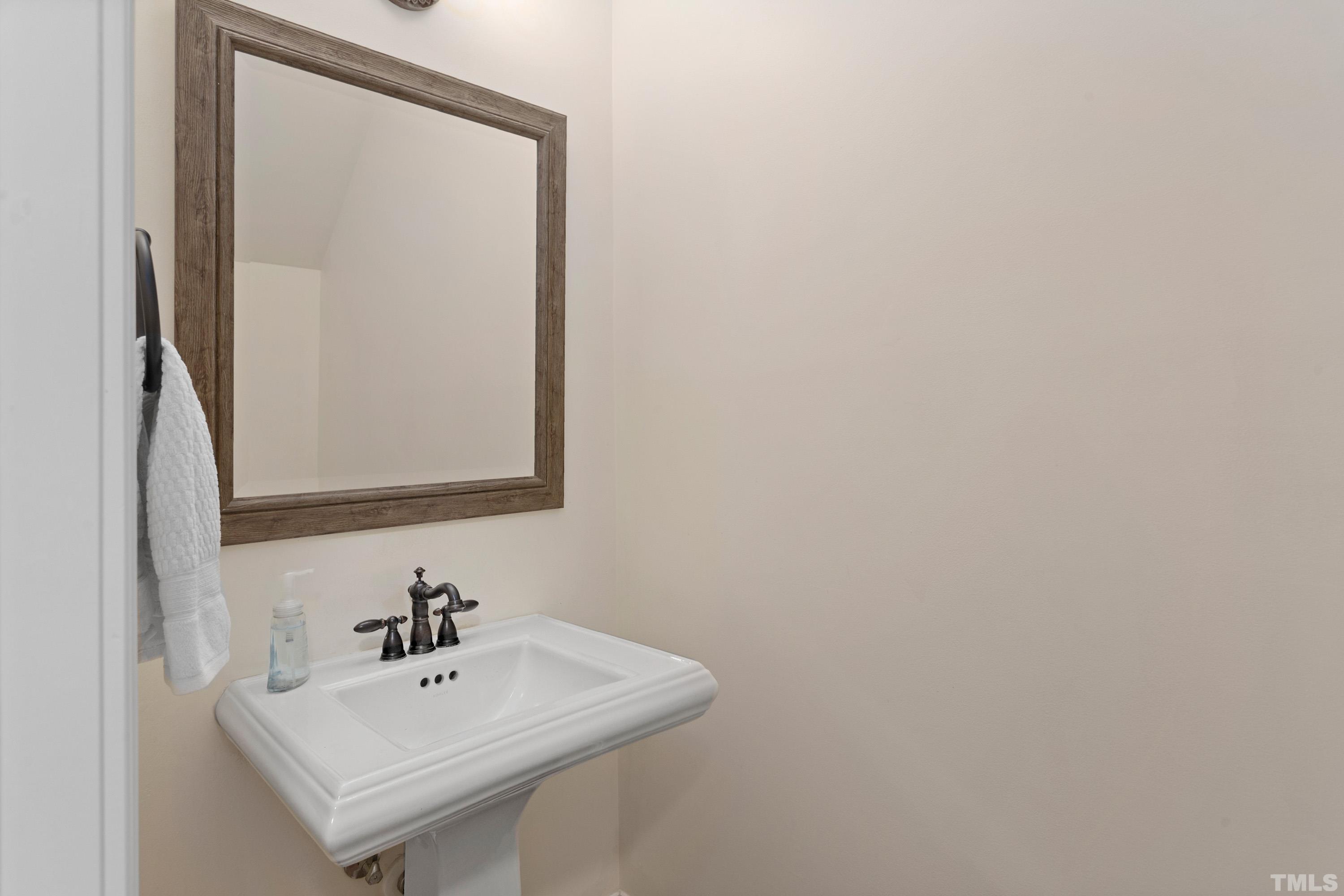 4324 Summer Brook Drive Apex, NC 27539 - Photo 20 of 70 a bathroom with a sink a mirror and a vanity