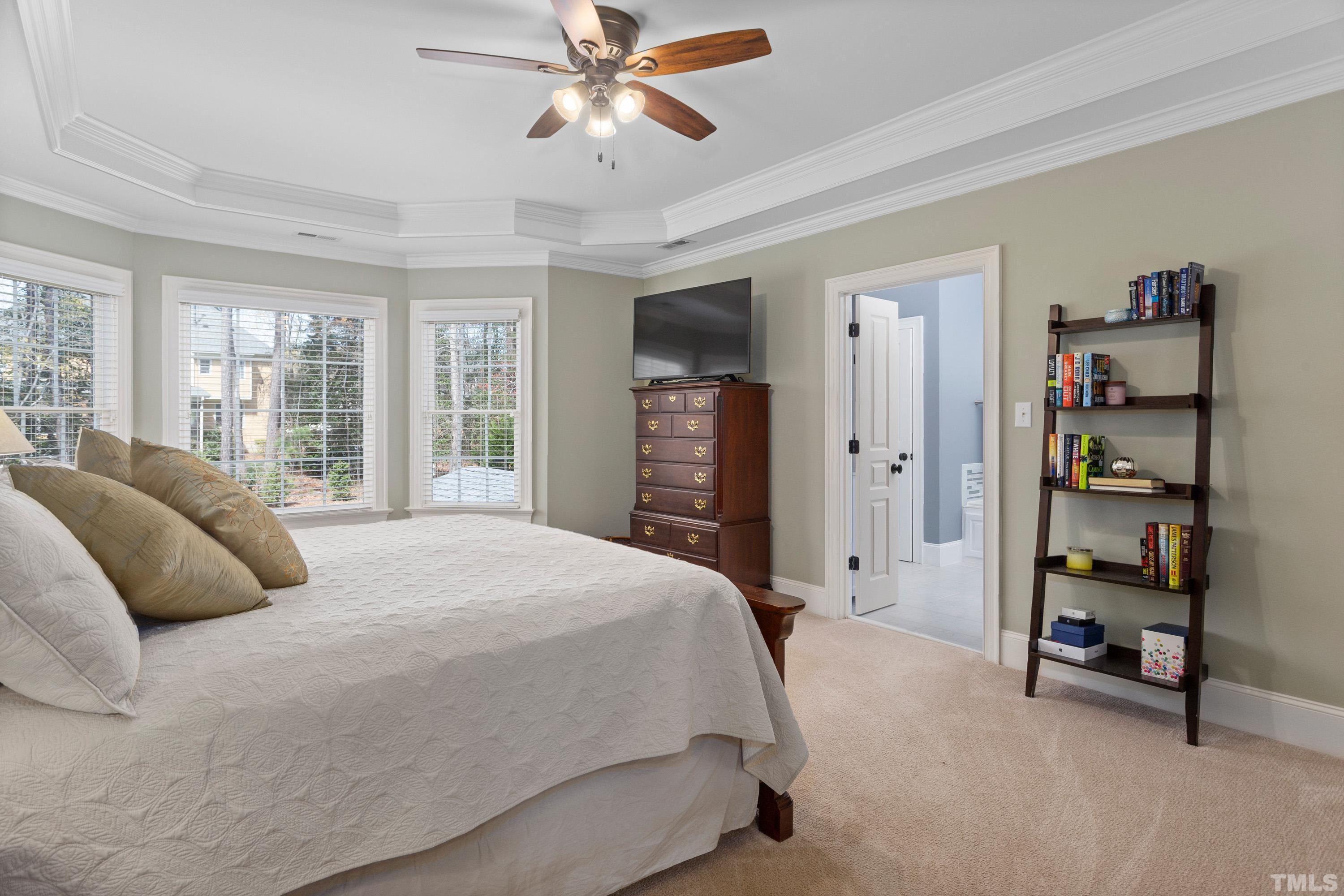 4324 Summer Brook Drive Apex, NC 27539 - Photo 23 of 70 a bedroom with a bed and a chandelier