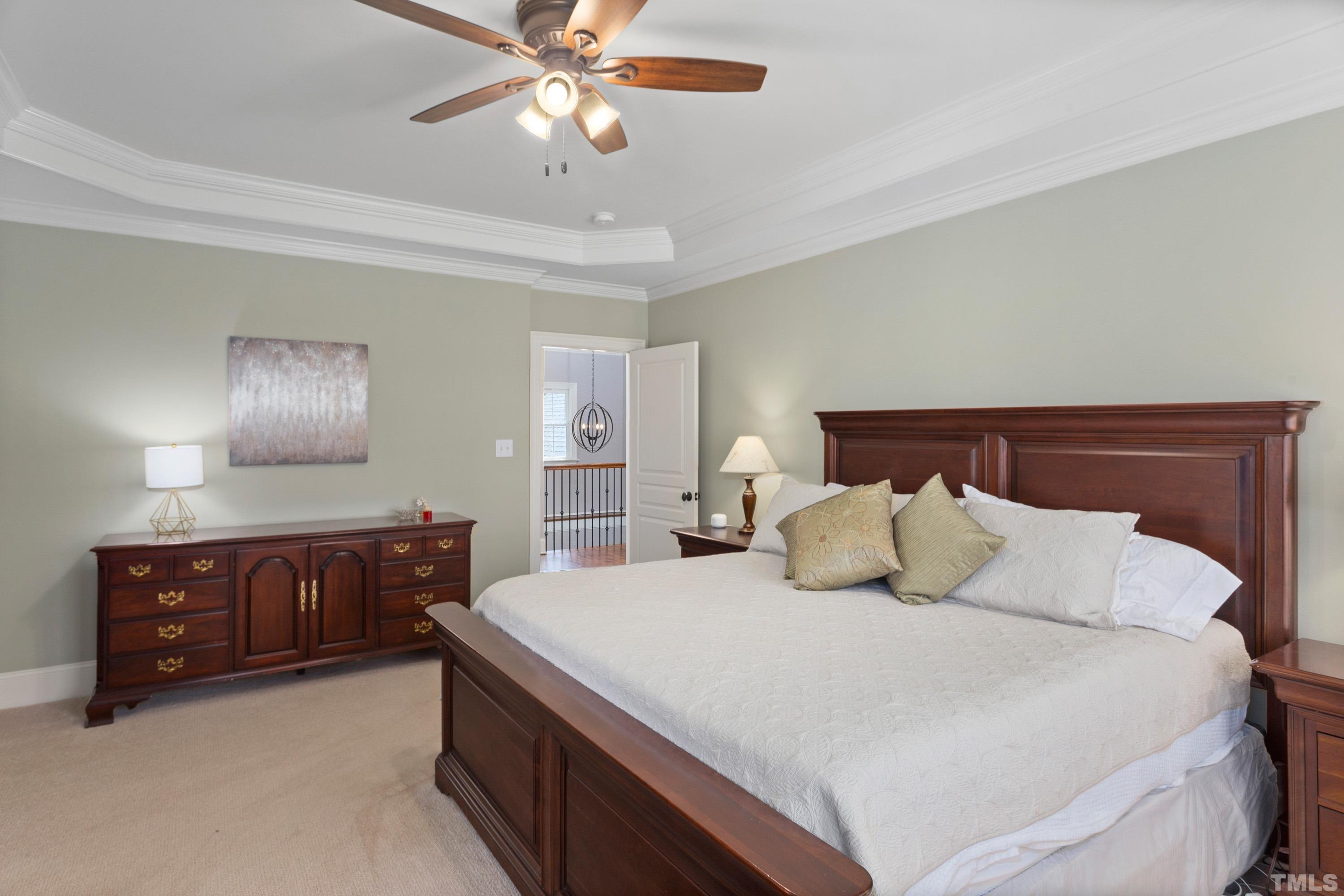 4324 Summer Brook Drive Apex, NC 27539 - Photo 24 of 70 a bedroom with a large bed and a dresser