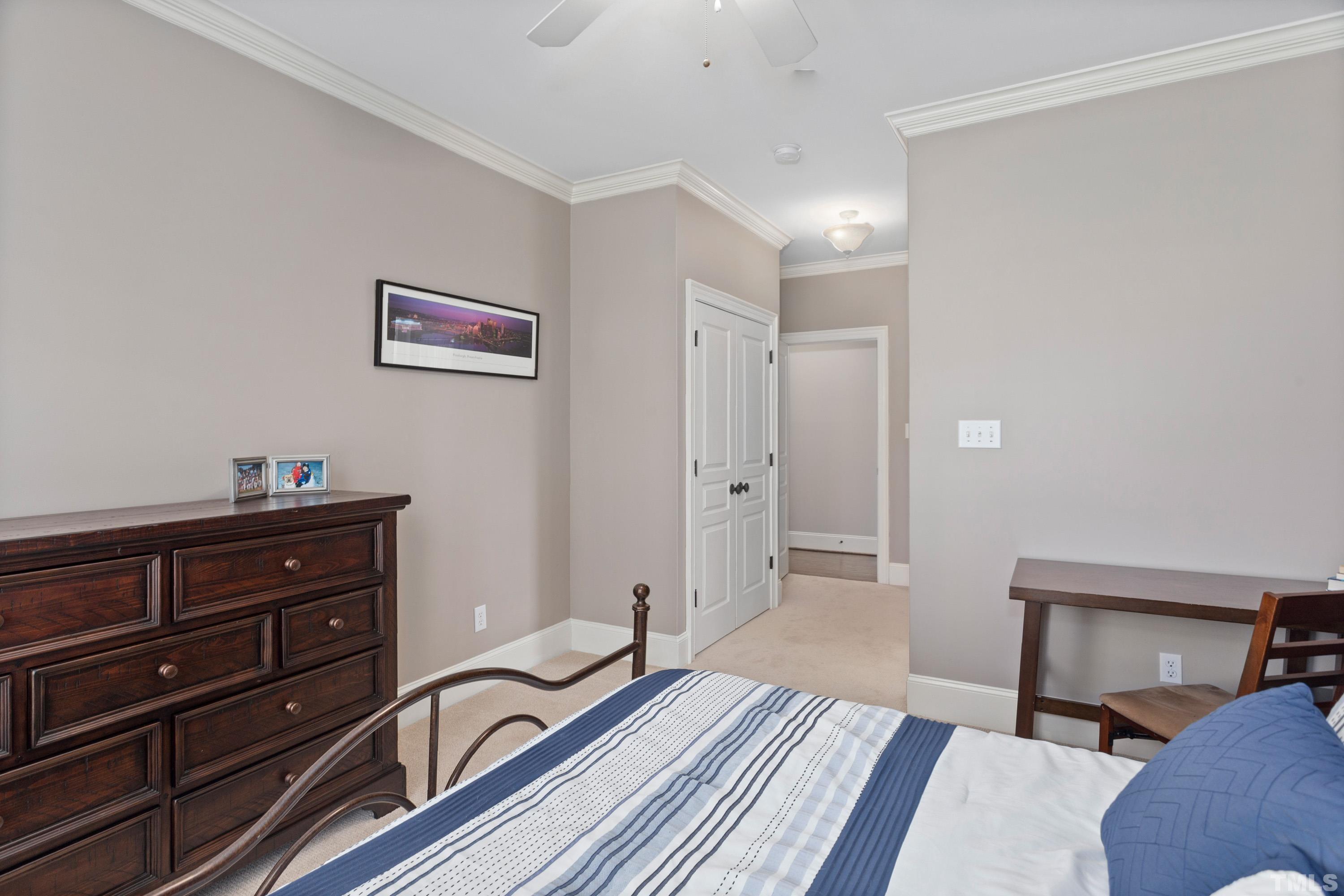 4324 Summer Brook Drive Apex, NC 27539 - Photo 36 of 70 a bedroom with a bed and a dresser in it