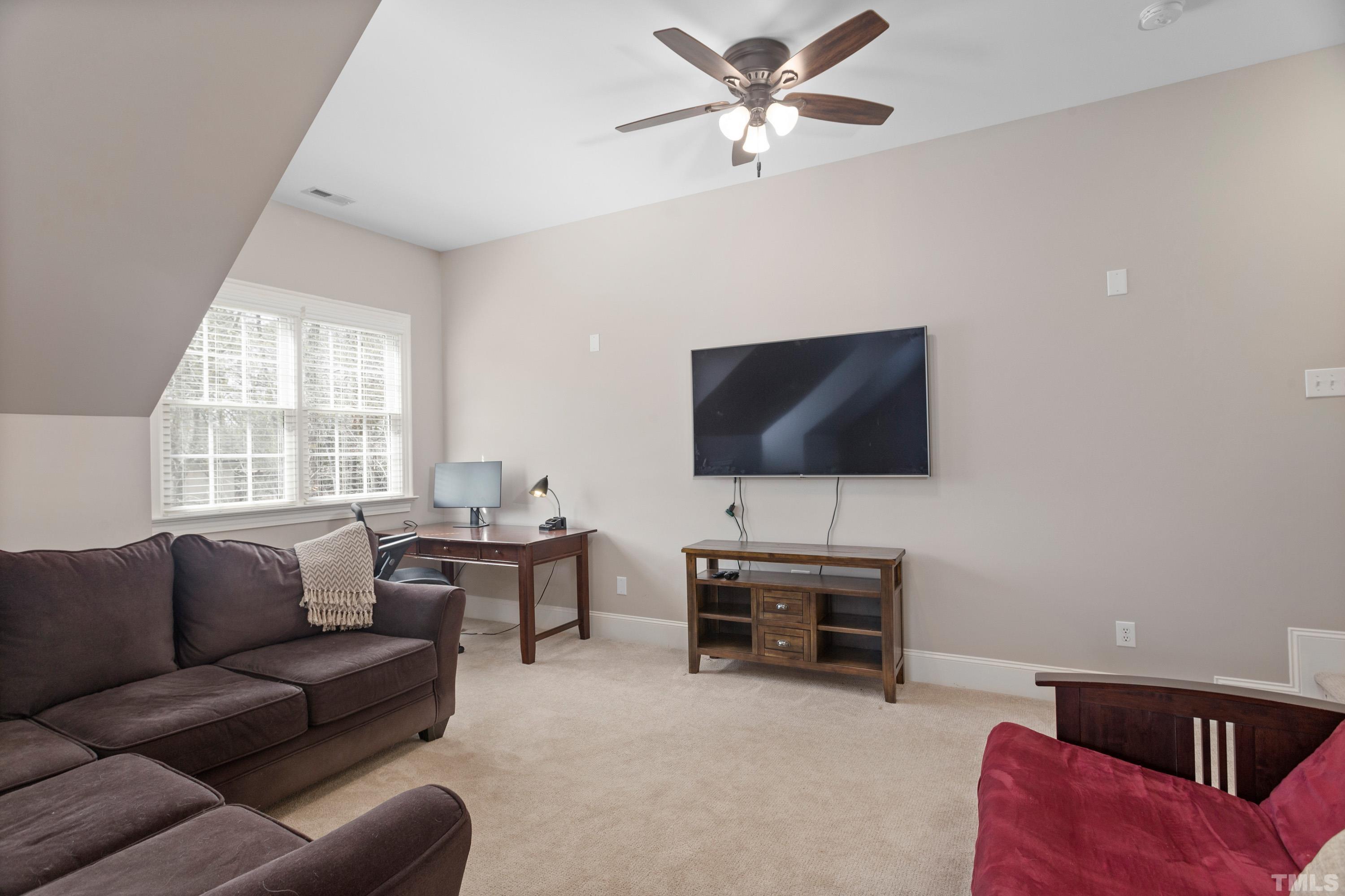 4324 Summer Brook Drive Apex, NC 27539 - Photo 41 of 70 a living room with furniture and a flat screen tv