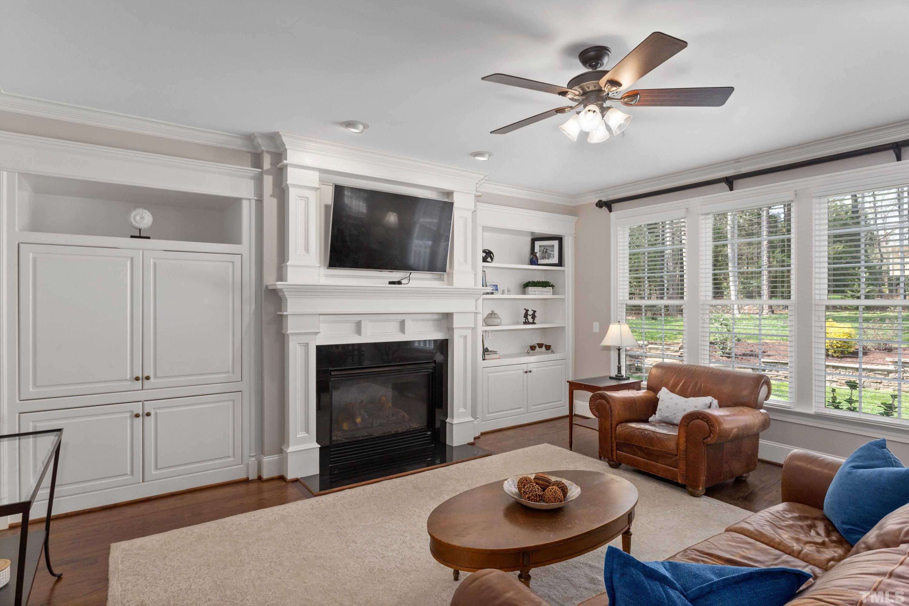 4324 Summer Brook Drive Apex, NC 27539 - Photo 7 of 70 a living room with furniture a fireplace and a flat screen tv