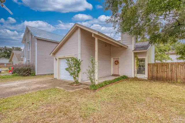 a view of a house with a yard and garage
