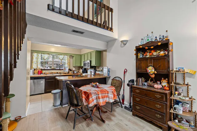 a dining hall with furniture a chandelier and a fireplace