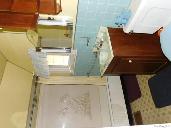 a picture of a bathroom with a sink and mirror