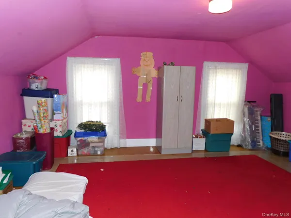 a bedroom with furniture and a window