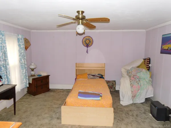 a bedroom with a bed and window