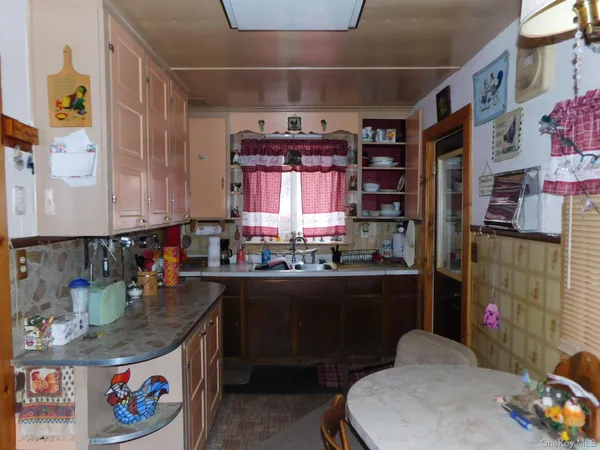 a kitchen with a refrigerator and a stove