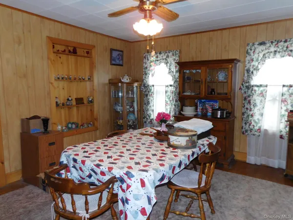 a view of a dining room with furniture and chandelier