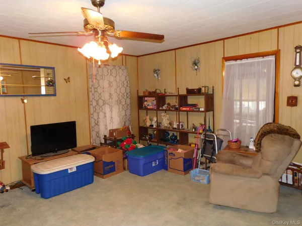 a living room with furniture a fireplace and a chandelier