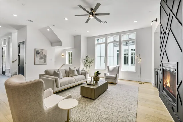 a living room with furniture a large window and a flat screen tv