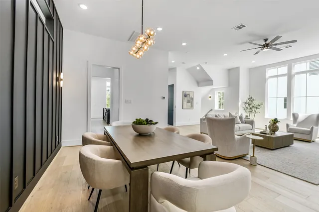 a view of a dining room with furniture and chandelier