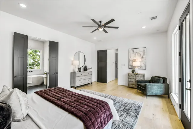 a bedroom with a bed and ceiling fan