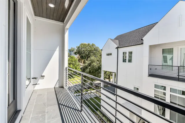 a view of balcony with wooden floor and fence