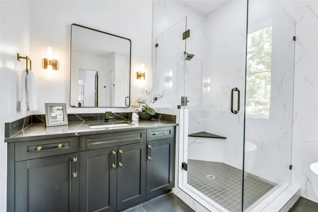 a bathroom with a shower sink and mirror
