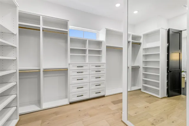 a view of walk in closet with empty racks