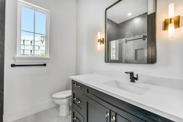 a bathroom with a sink a toilet and mirror