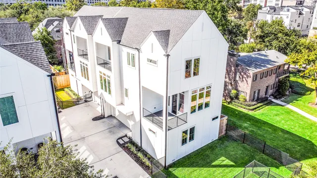 a view of residential house with backyard and trees