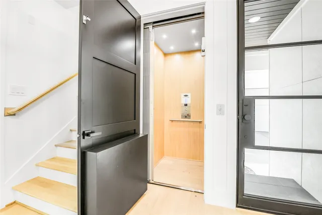 a view of a kitchen with a refrigerator and a window