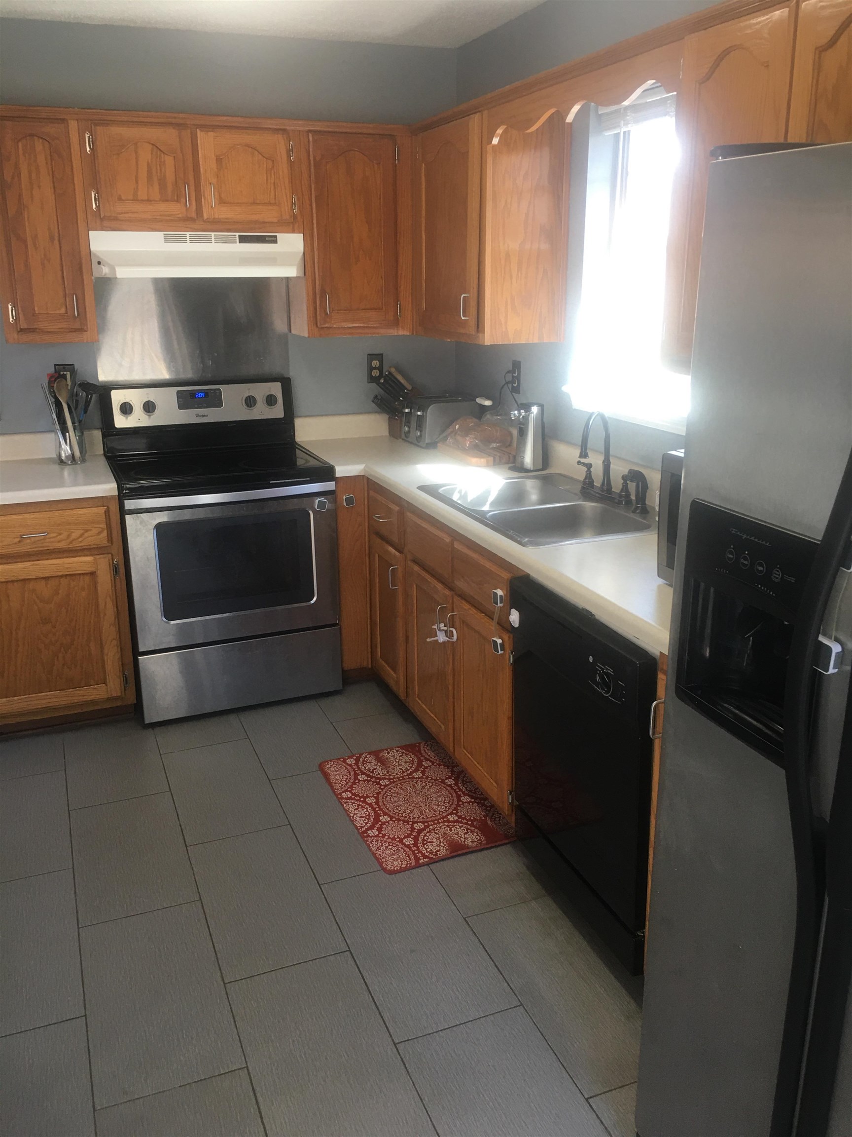 1605 Marie Road Cordova, TN 38016 - Photo 3 of 20 a kitchen with a sink stove and cabinets