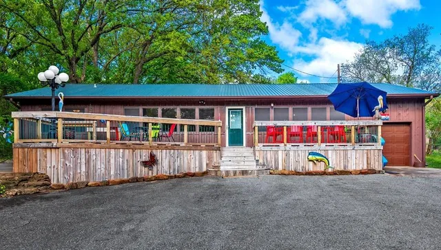 a view of a house with a yard and deck