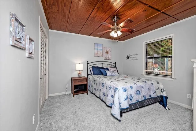 a bedroom with a bed couch and window