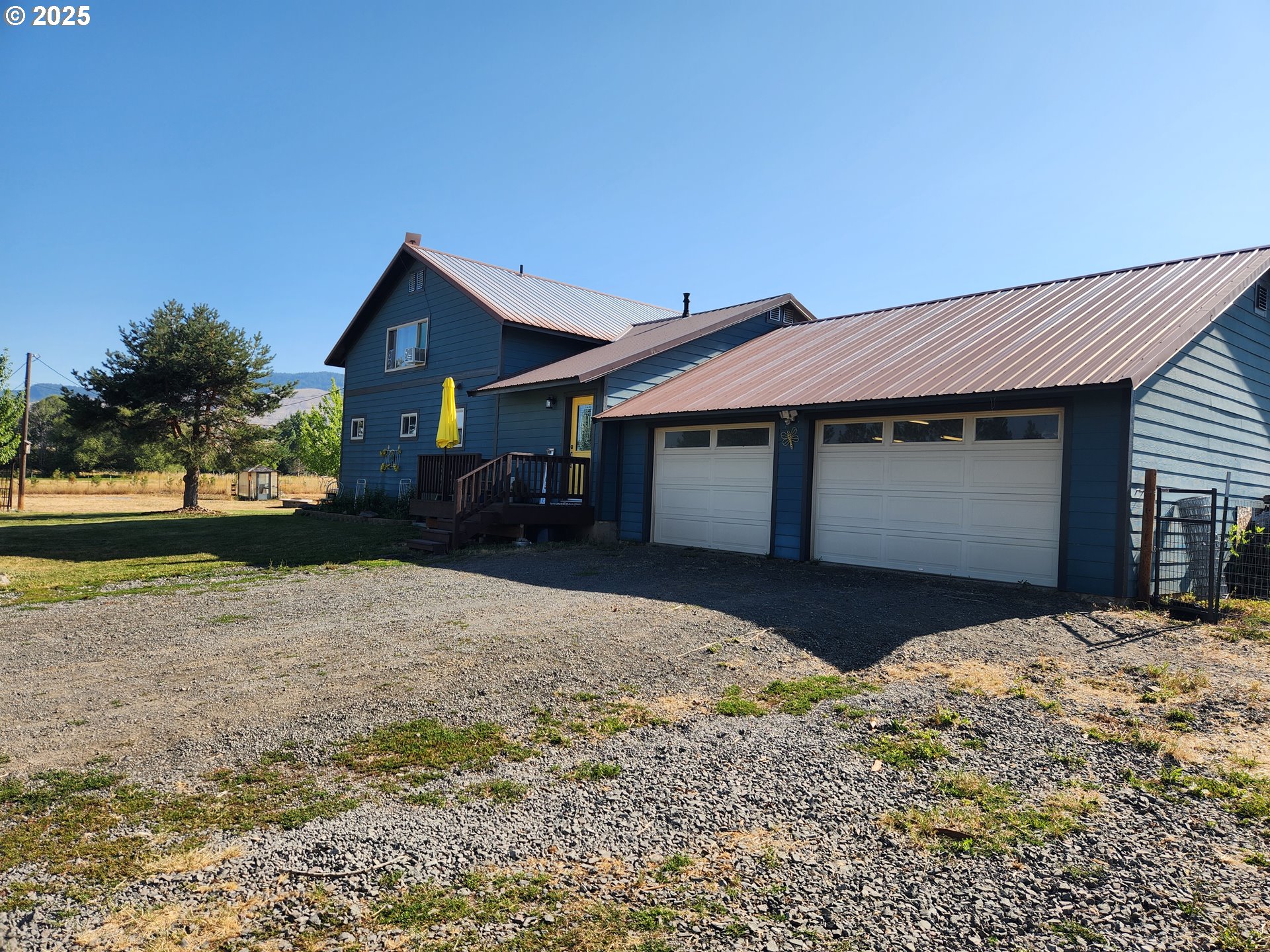 1008 Foster Street Cove, OR 97824 - Photo 1 of 33 a front view of a house with a yard and garage