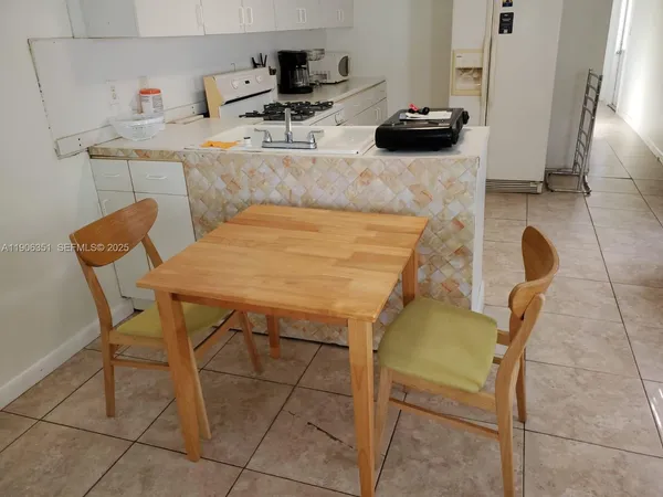 a kitchen with a table and chairs in it