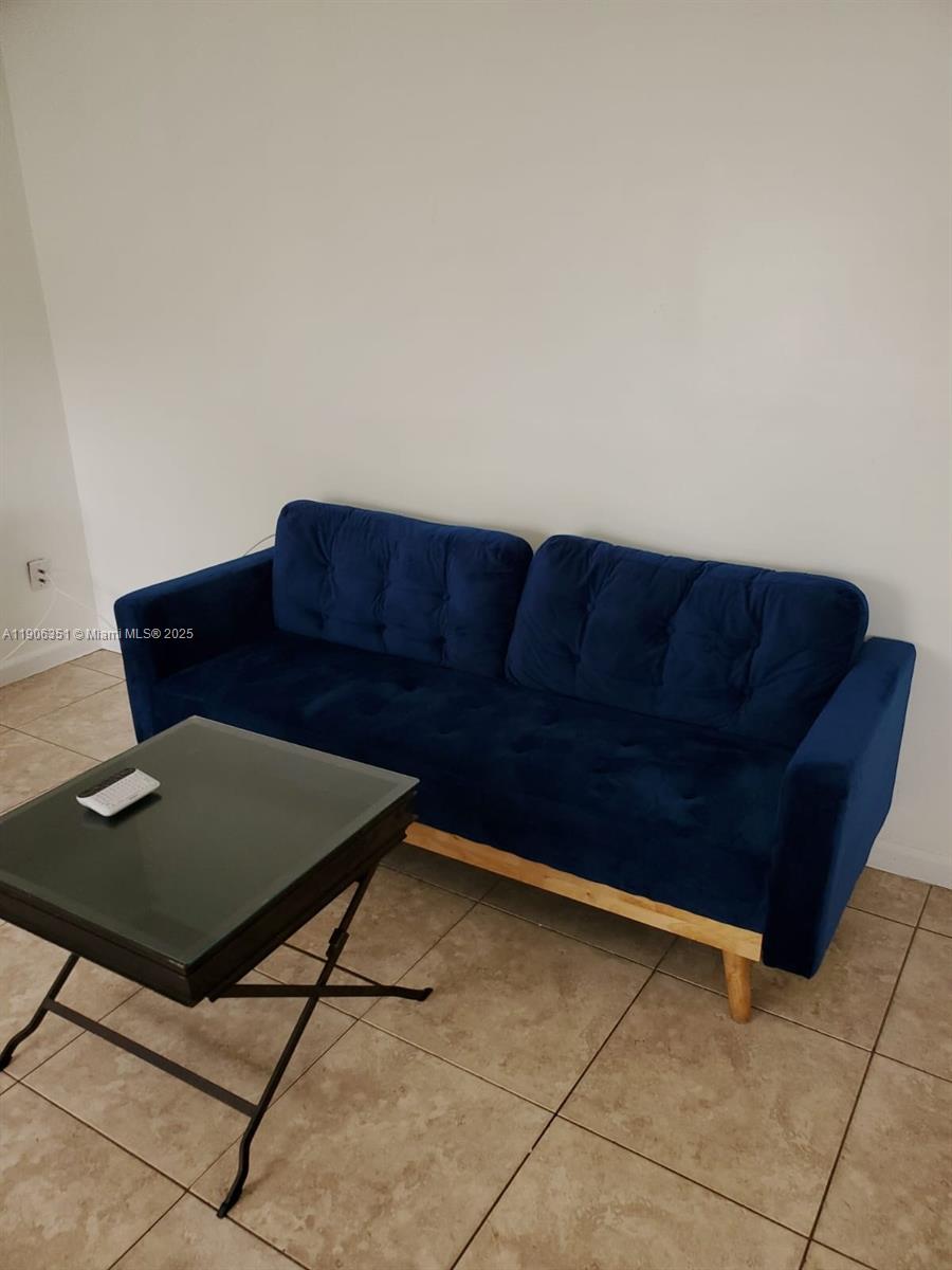 13101 Southwest 14th Street, Unit 1 Miami, FL 33184 - Photo 2 of 12 a living room with a couch and a stove top oven