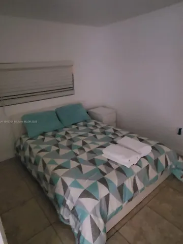 a bed sitting in a bedroom next to a cabinet