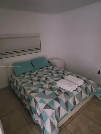 a bed sitting in a bedroom next to a cabinet