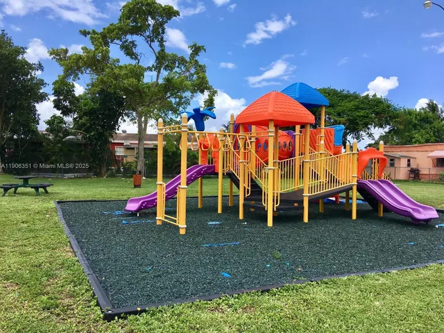 a view of outdoor space with playground and green space