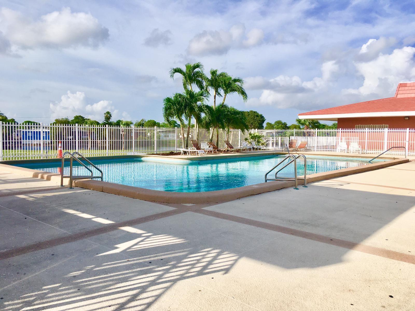 13101 Southwest 14th Street, Unit 1 Miami, FL 33184 - Photo 10 of 12 a view of a swimming pool with a patio