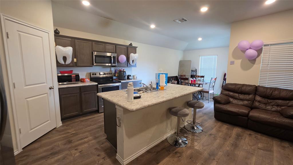 409 Samuel Street Denton, TX 76207 - Photo 26 of 40 a view of kitchen center island and stainless steel appliances