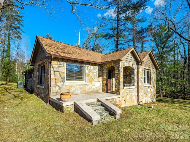 a front view of a house with a yard table and chairs