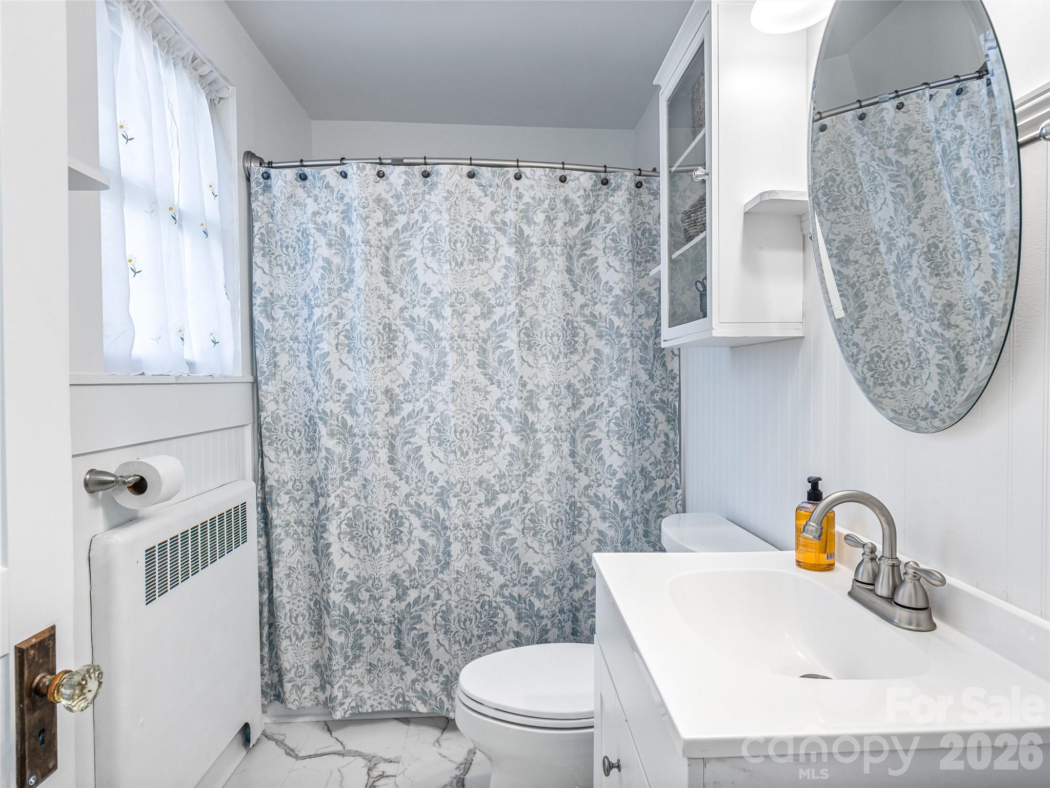 104 Campground Road Hendersonville, NC 28791 - Photo 18 of 32 a bathroom with a sink a toilet and shower curtain