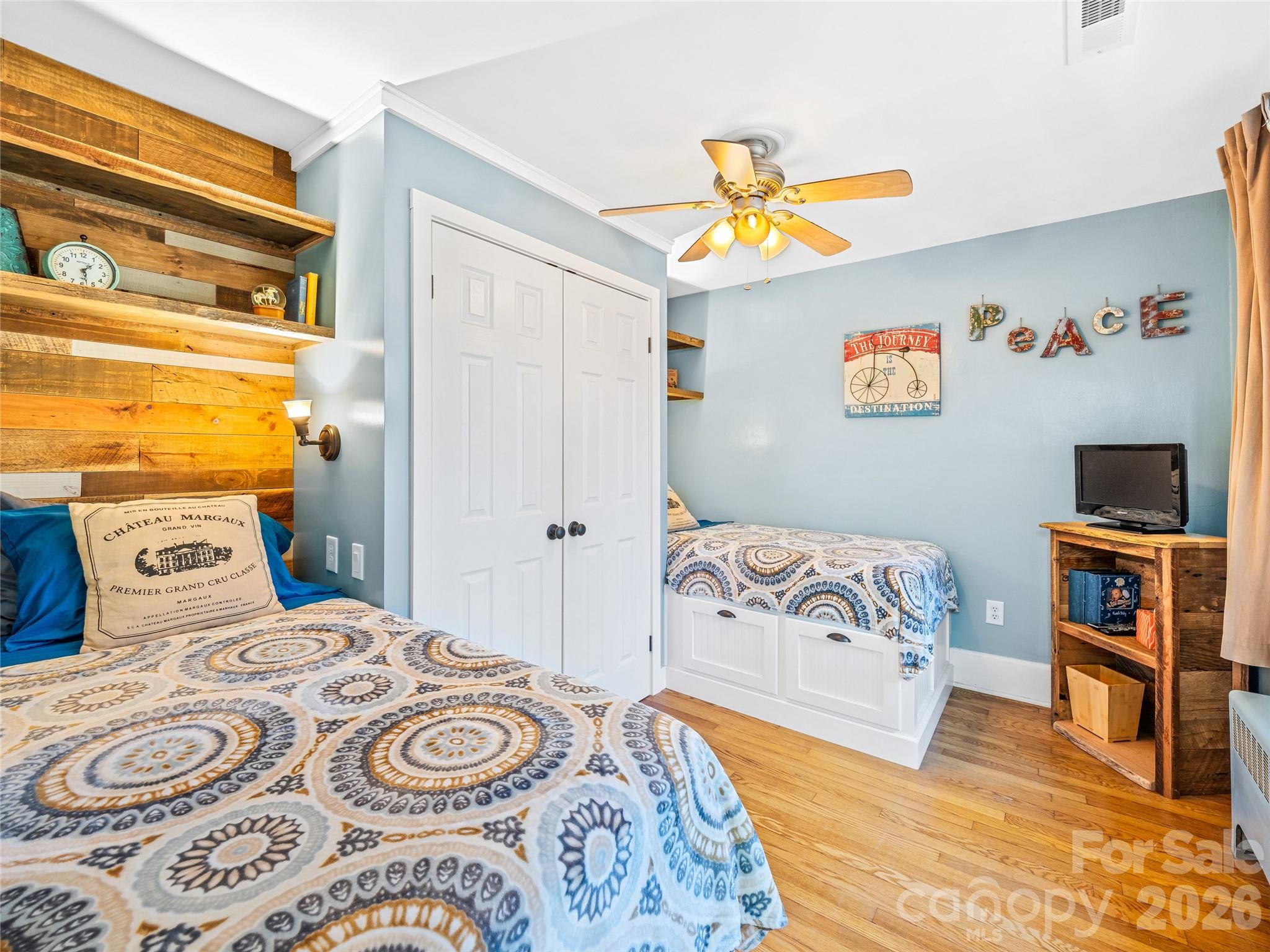 104 Campground Road Hendersonville, NC 28791 - Photo 19 of 32 a bedroom with a bed and wooden floor