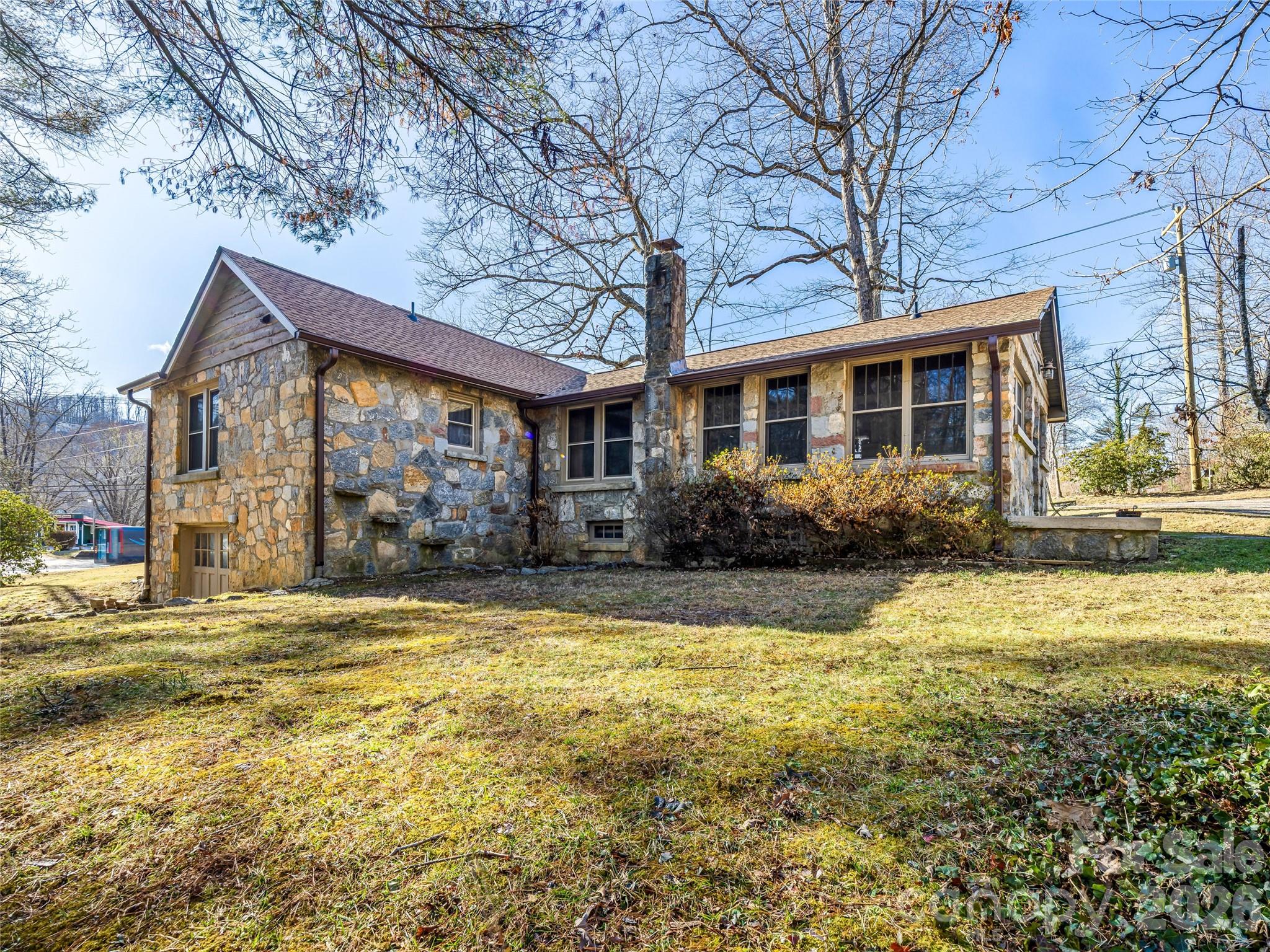 104 Campground Road Hendersonville, NC 28791 - Photo 2 of 32 a view of a house with a swimming pool