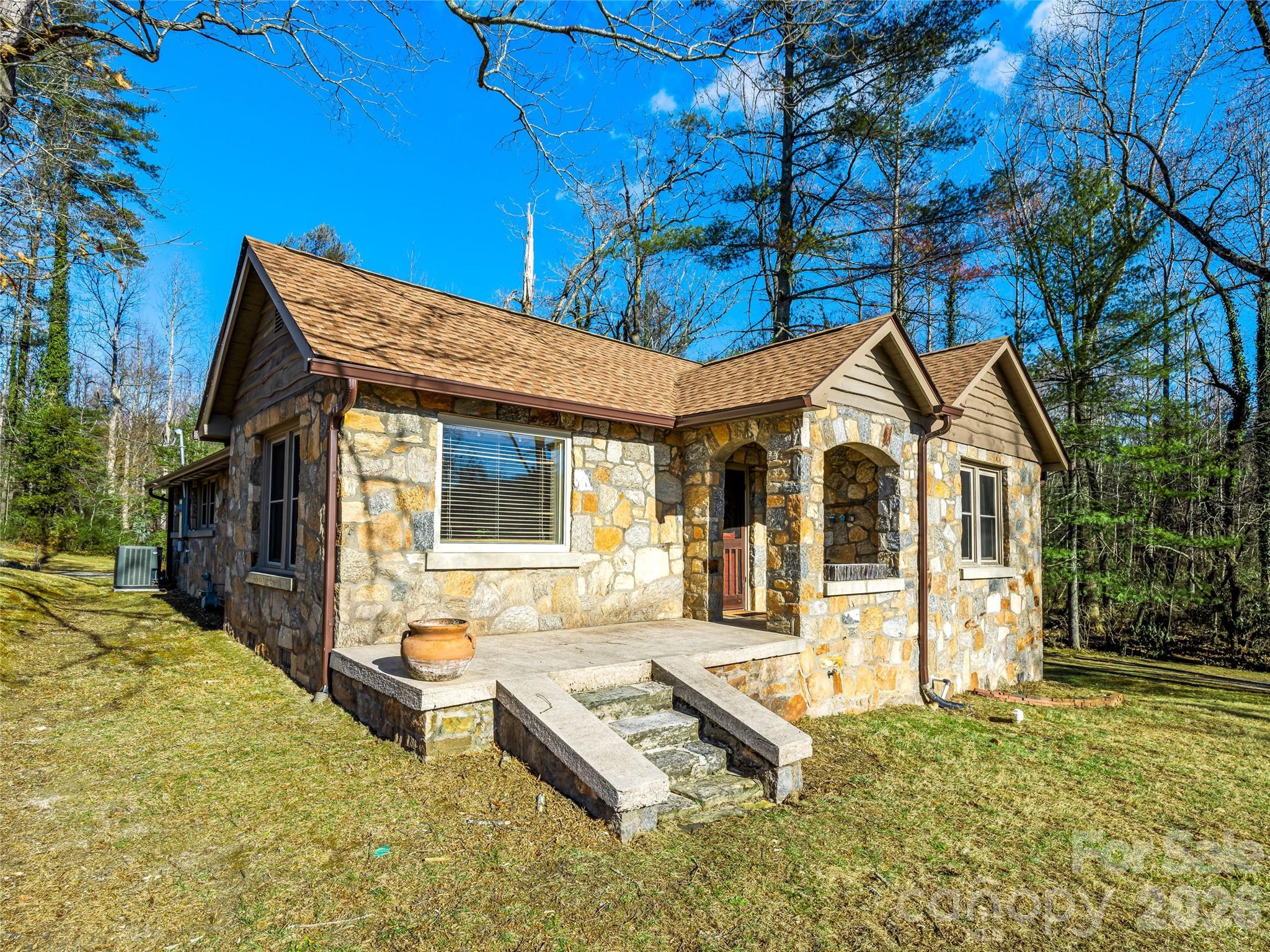 104 Campground Road Hendersonville, NC 28791 - Photo 2 of 32 a front view of a house with a yard table and chairs