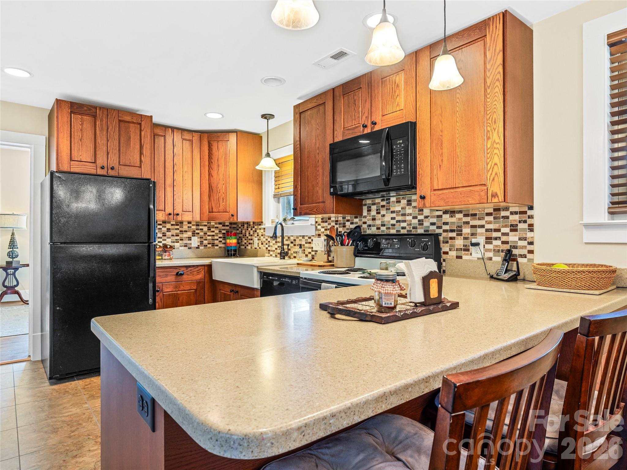 104 Campground Road Hendersonville, NC 28791 - Photo 6 of 32 a kitchen with kitchen island granite countertop a sink a stove and a refrigerator