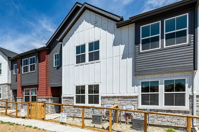 a front view of a house with large windows