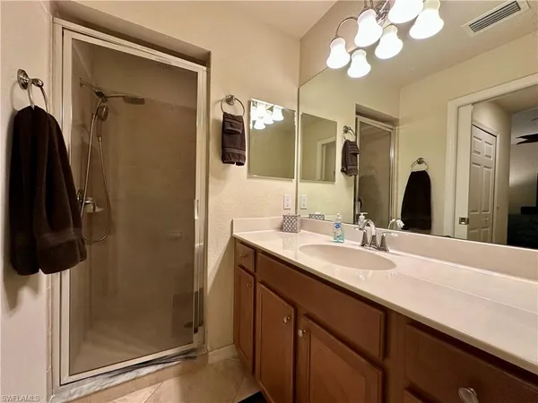 a bathroom with a sink a mirror and shower