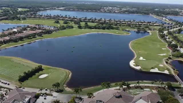 an aerial view of a house with a lake view