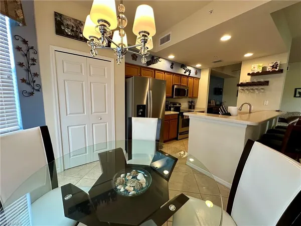a living room with furniture a flat screen tv and a large mirror