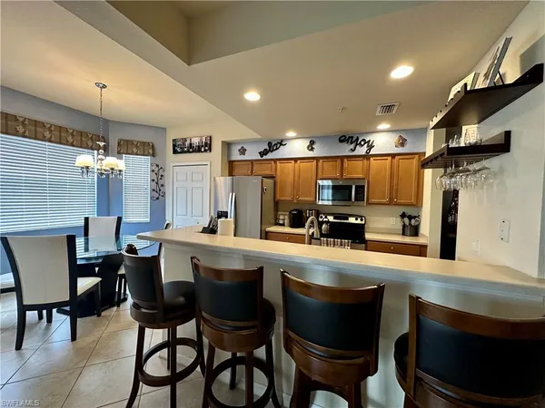a large kitchen with a table and chairs