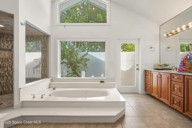 a spacious bathroom with bathtub and window