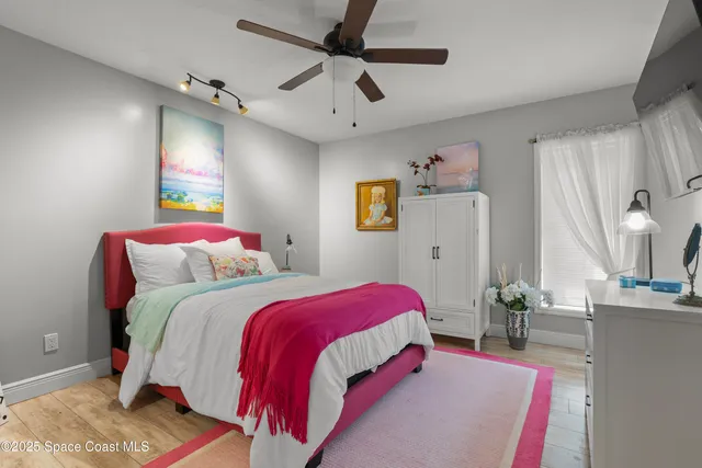 a bed room with a bed and a chandelier