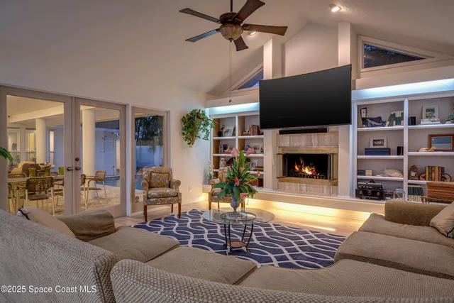 a living room with furniture a flat screen tv and a fireplace