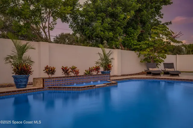 a view of a swimming pool and lounge chair