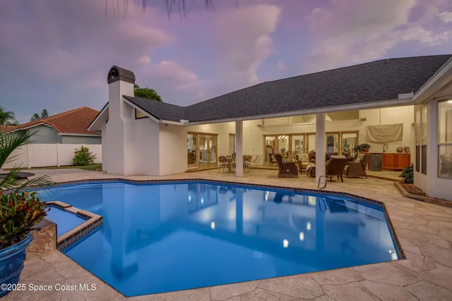 a view of a living room with a floor to ceiling window and potted plants